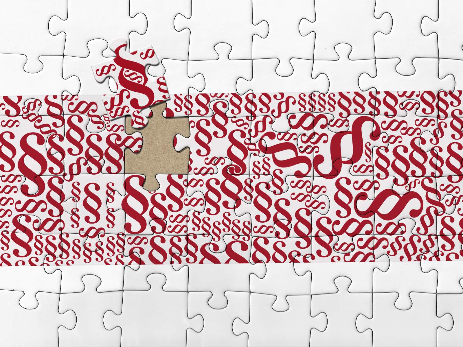 Puzzle mit vielen roten Paragrafenzeichen. 
